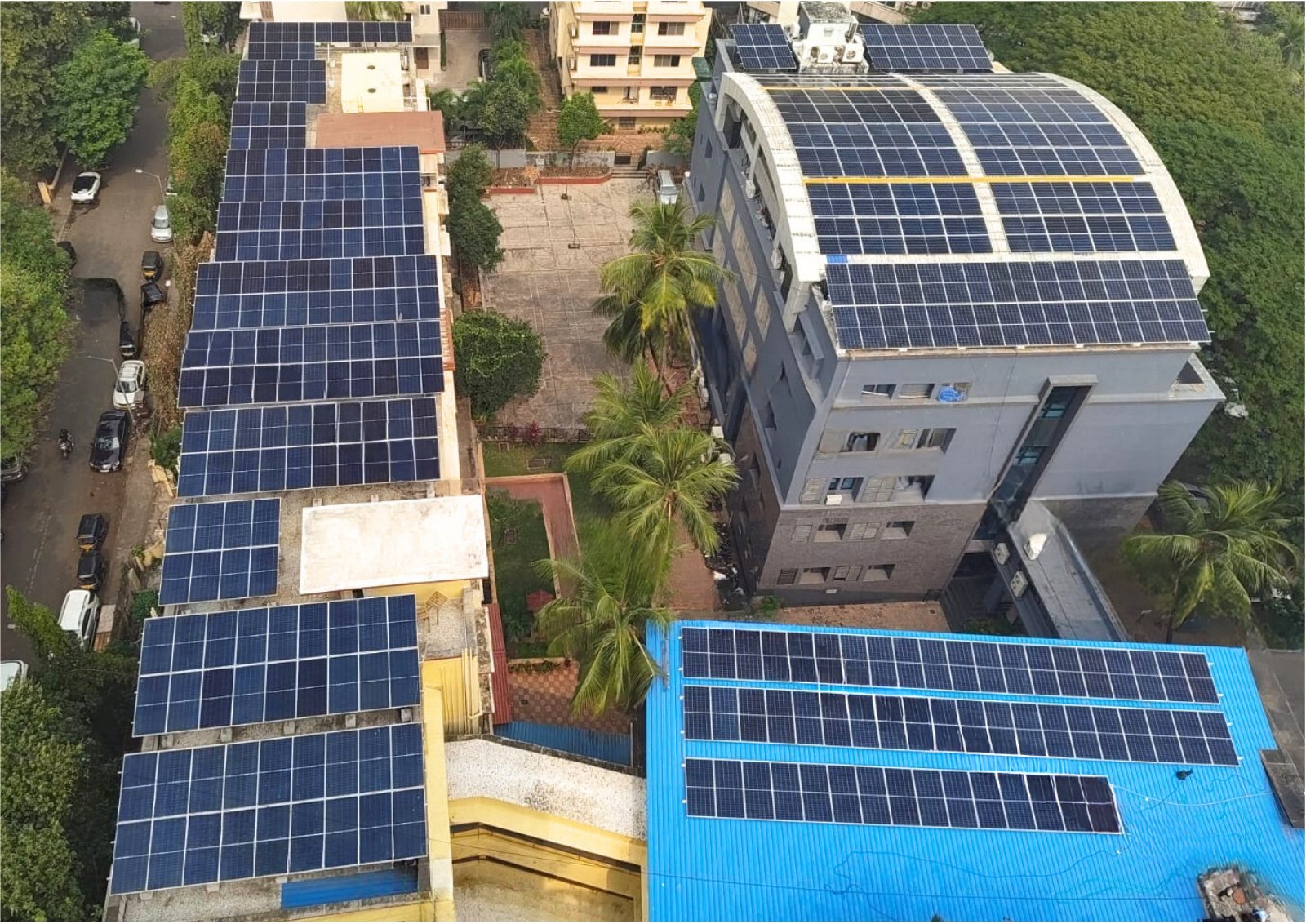 Aerial view of solar panels installed across the St. Paul's Trust campus rooftops in Bandra West